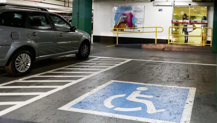 Foto de uma vaga vazia para pessoa com deficiência em estacionamento.